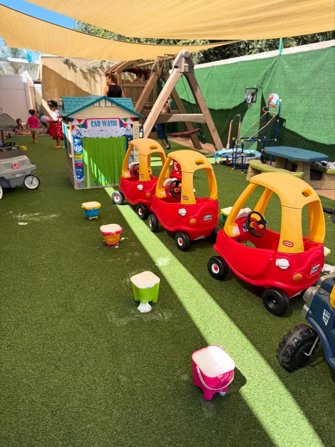 Children in costumes playing at the outdoor Car Wash station