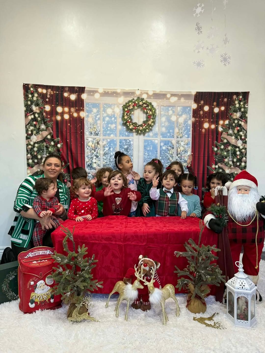 Group Christmas photo with the teacher and all the children in festive outfits