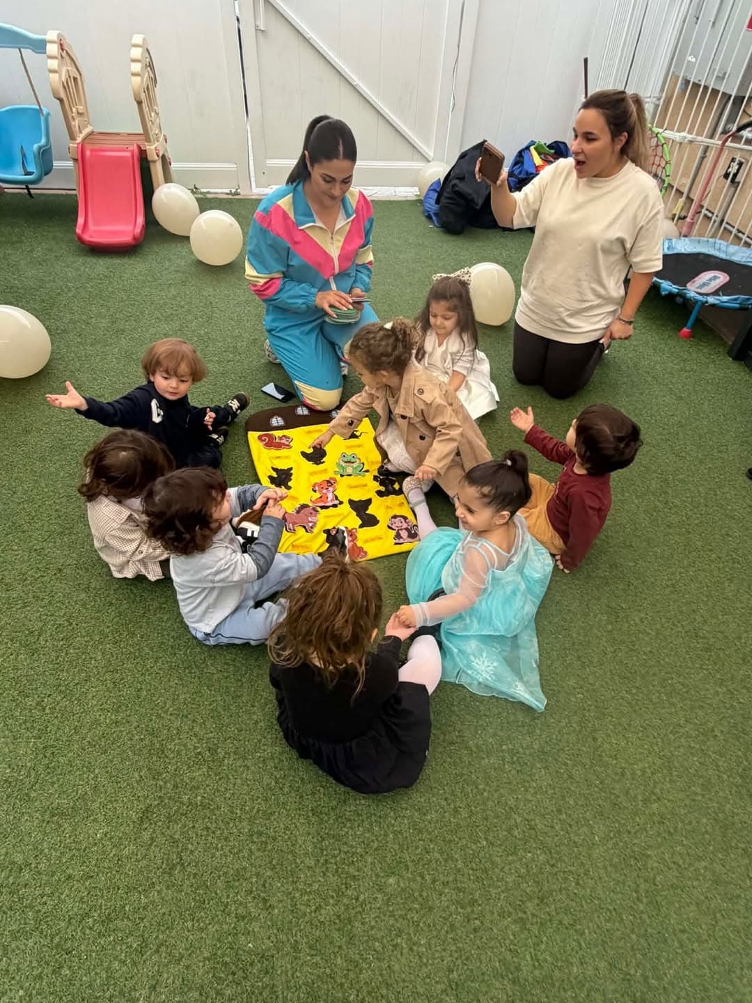 Children and teachers gathered in a circle for story time
