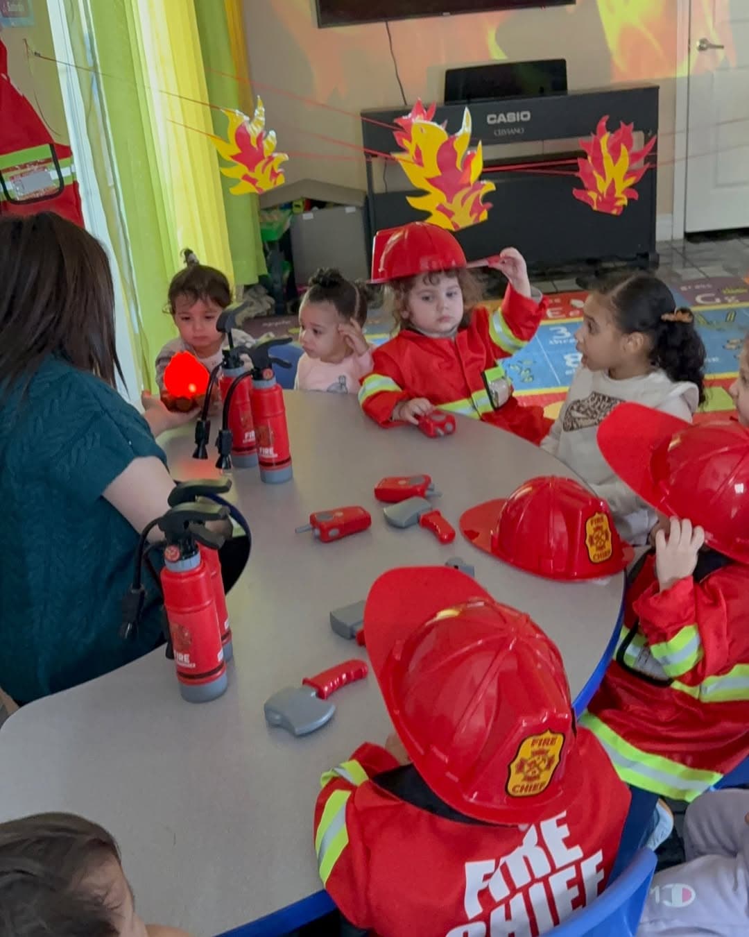 Children dressed as firefighters during a dress-up lesson